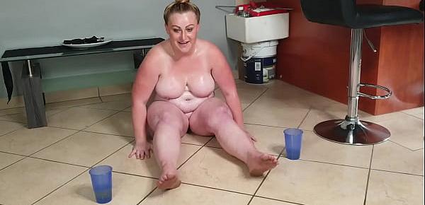  Busty fat slut playing in piss and sucking her piss covered toes